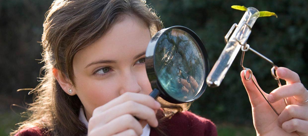 pupil looking through magnifying glass